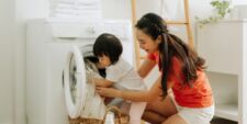 mother and toddler doing laundry Motherly