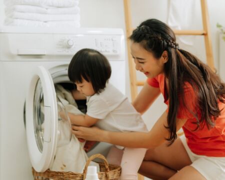 mother and toddler doing laundry Motherly