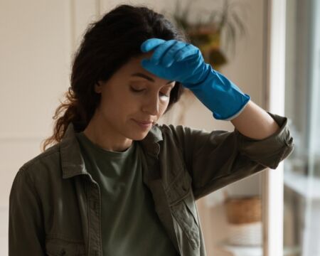 woman cleaning tired- holiday cleanup mental load