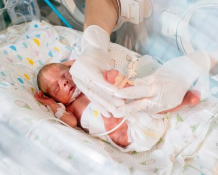 doctor checking on baby in the nicu Motherly