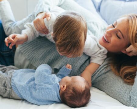 mom with baby and toddler Motherly