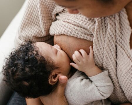 mother breastfeeding her infant son Motherly