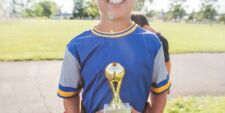 smiling child holding trophy