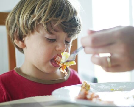 toddler boy rejecting fork of food Motherly