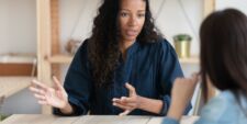 woman at work talking to her boss Motherly