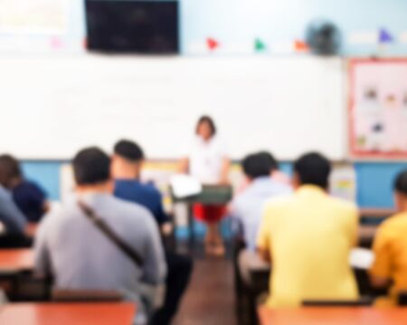 Blurred images of parents sitting in the classroom Motherly