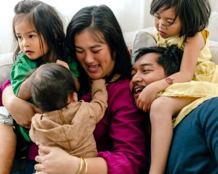 mom and dad with three kids Motherly