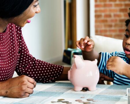 mom teaching son about saving money Motherly