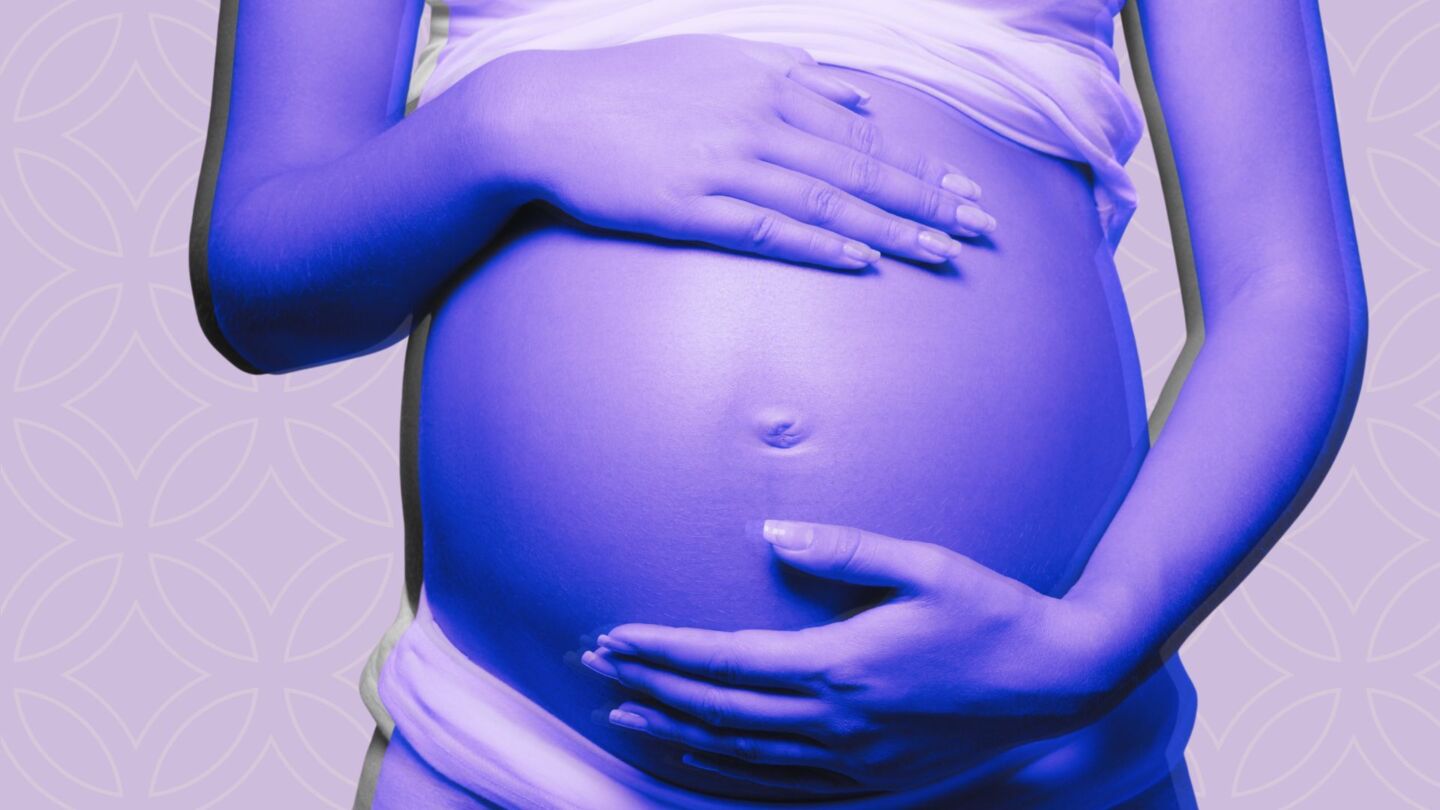 Woman holding pregnant belly
