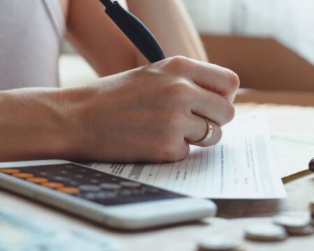 woman working on finances Motherly