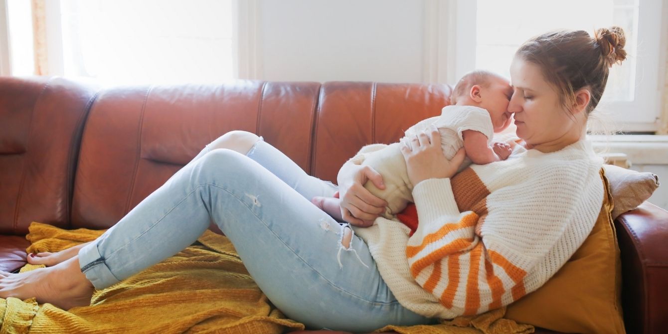 postpartum mom holding baby