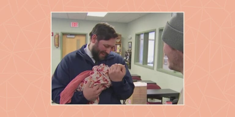 New Hampshire - Dispatcher holding the baby he helped deliver