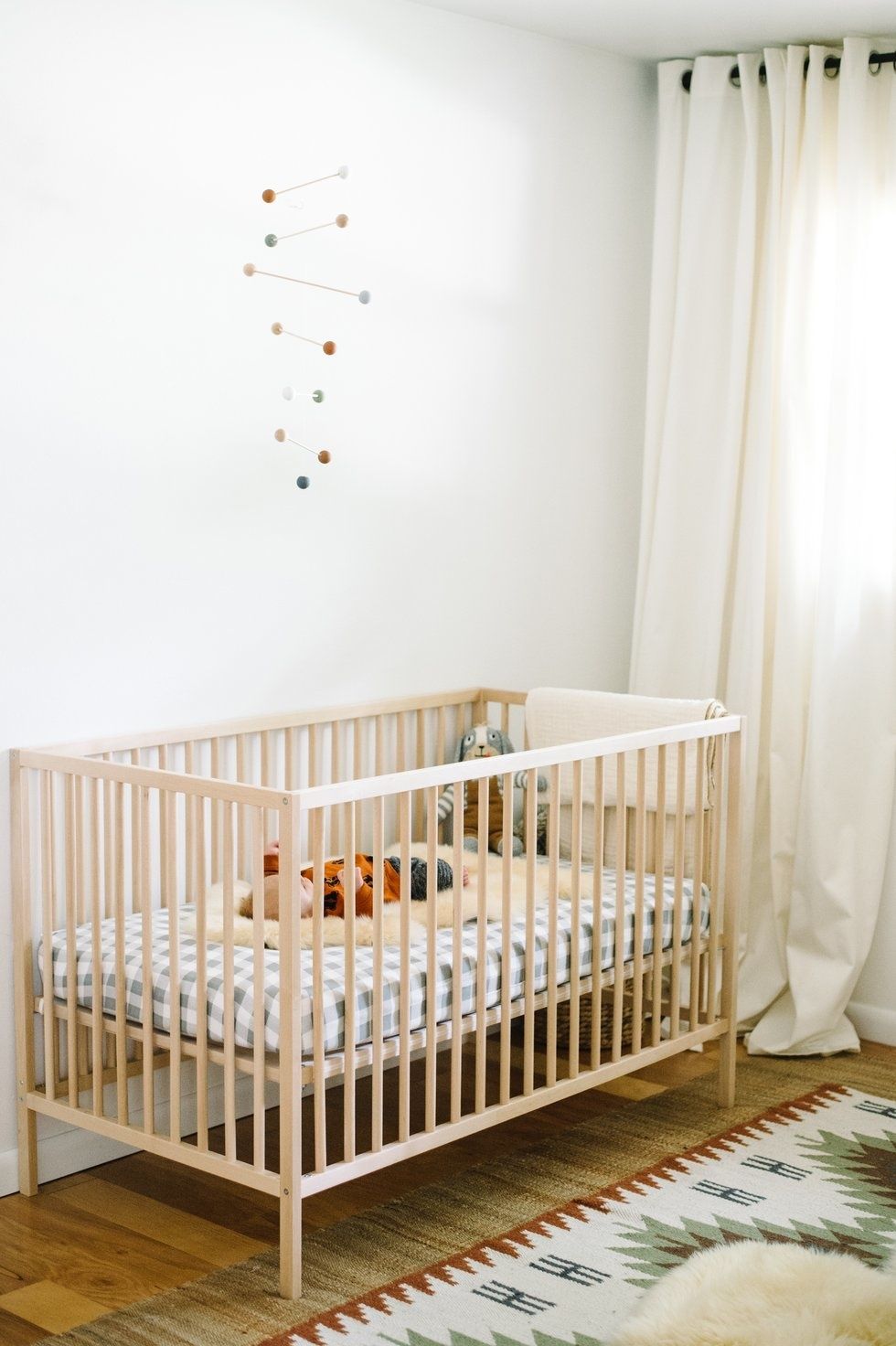 bohemian minimalist baby nursery 3 Motherly