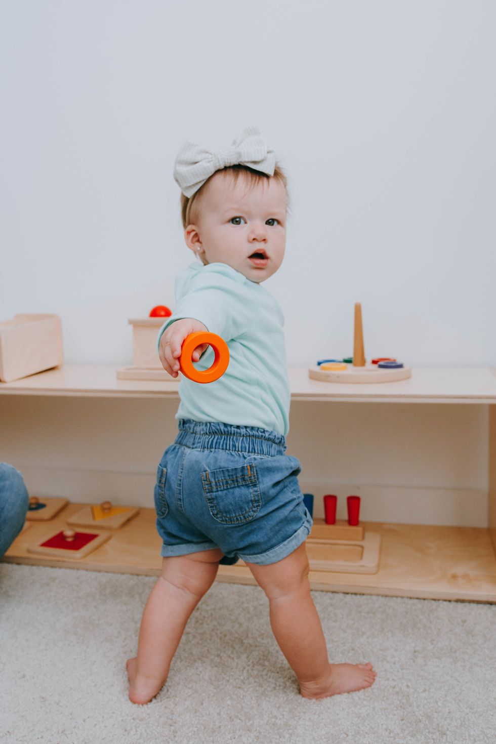 baby enjoying the benefits of montessori from birth in a nursery that allows freedom of movement