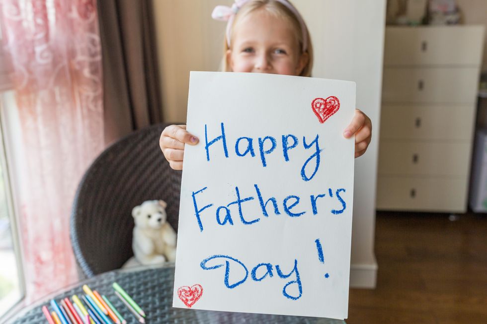 girl-holding-father's-day-sign