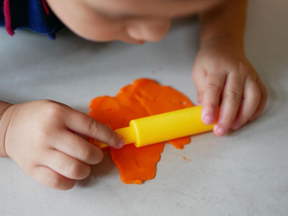 toddler playing with playdough