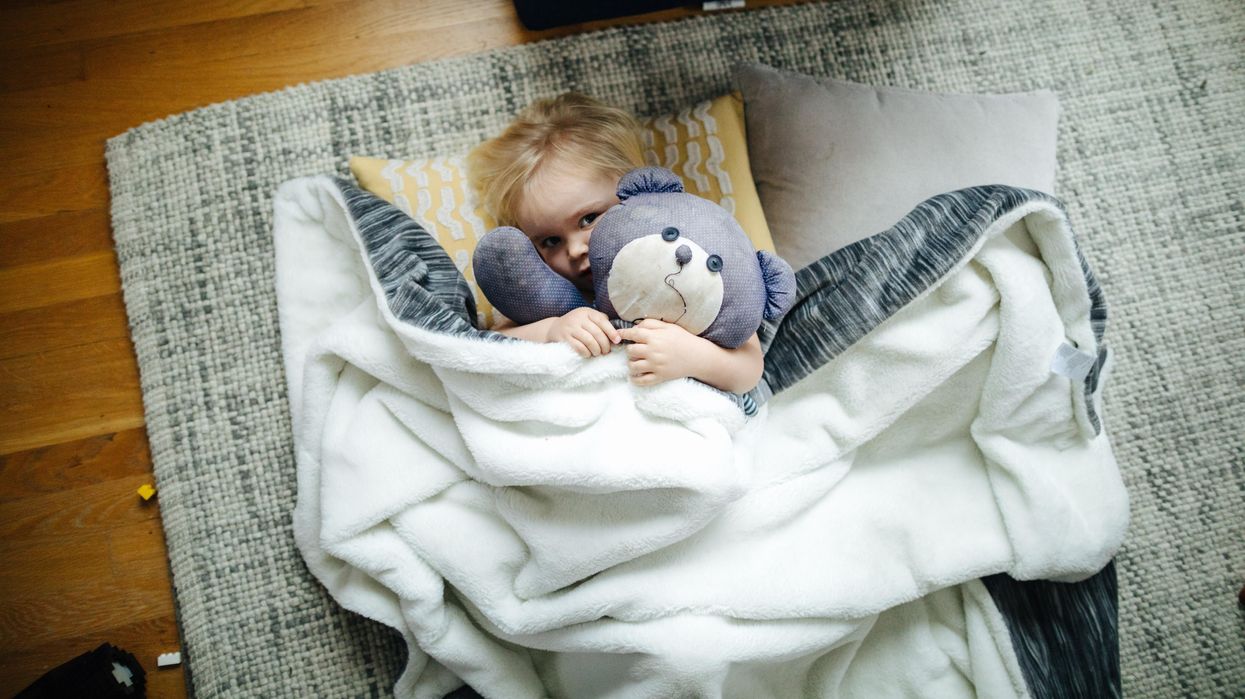 toddler on floor with blanket