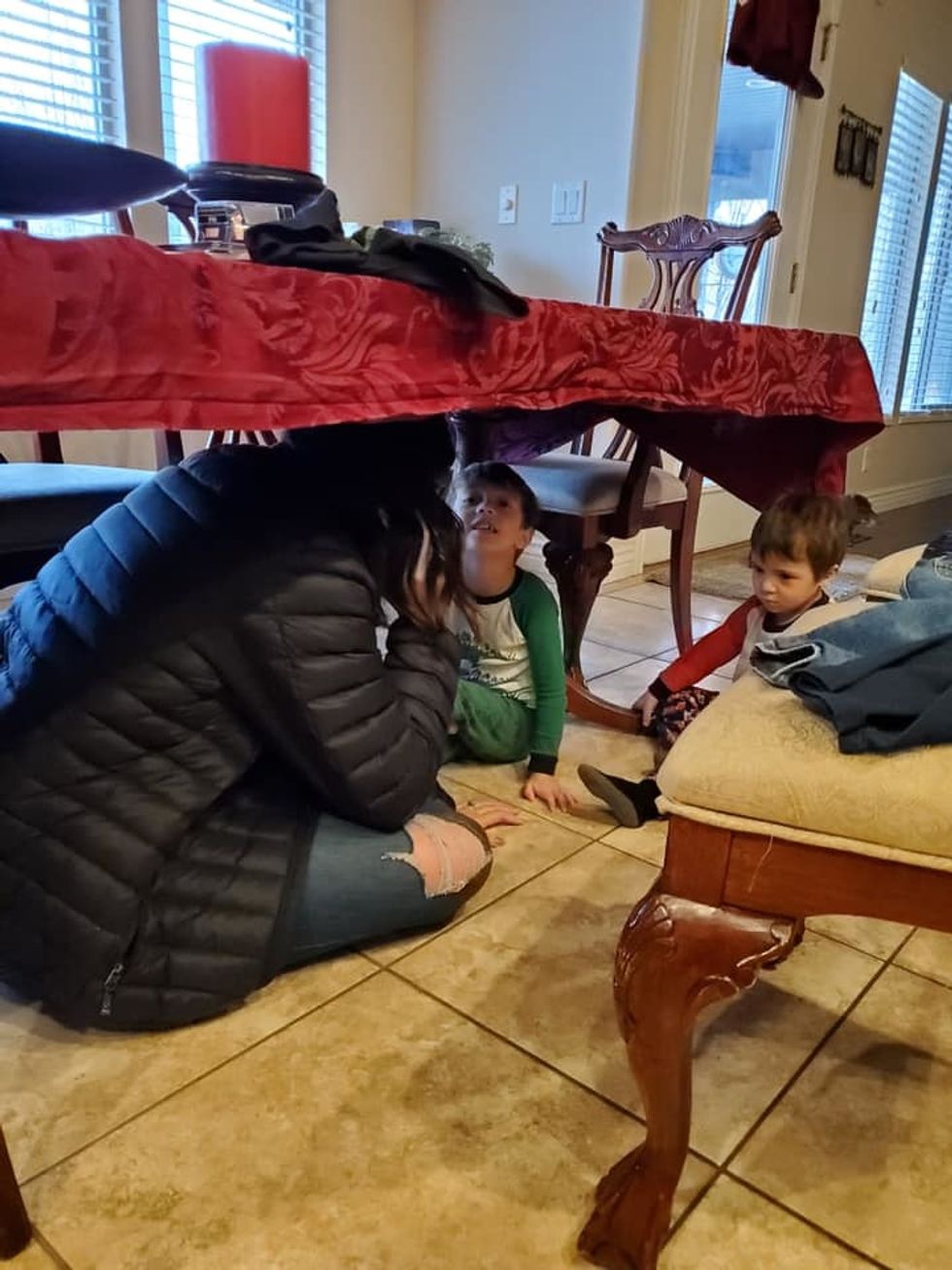 mom and kids under table