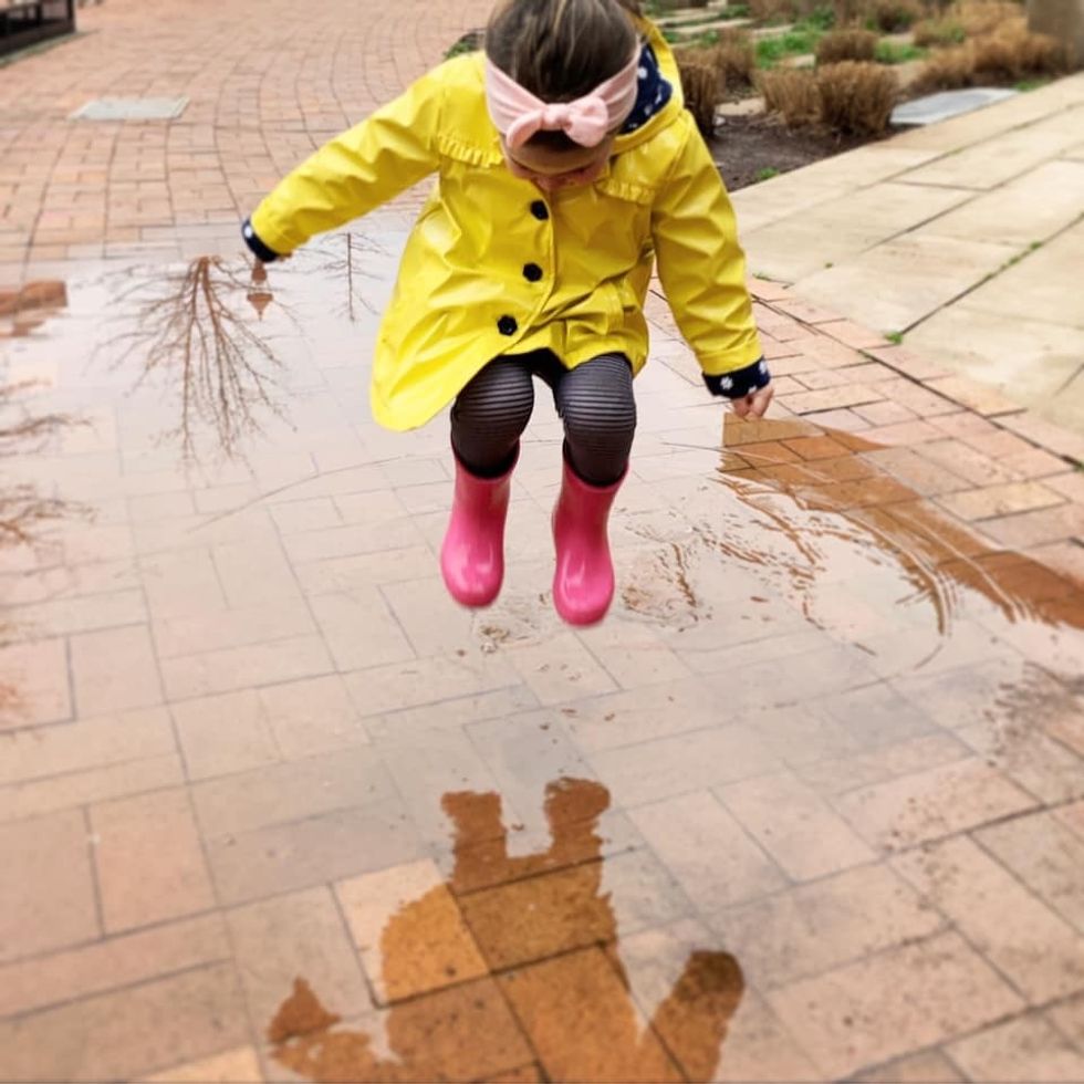 kid jumping in puddles